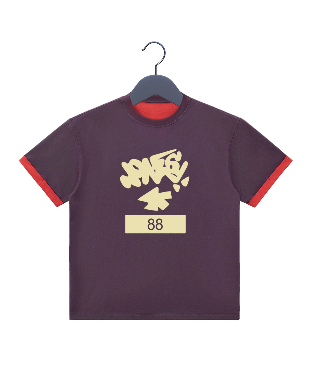 A dark purple ringer t-shirt with red trim on the sleeves and collar, featuring a cream-colored graffiti-style graphic that reads 'JONESYa+' above the number '88' on a cream block.