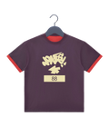 A dark purple ringer t-shirt with red trim on the sleeves and collar, featuring a cream-colored graffiti-style graphic that reads 'JONESYa+' above the number '88' on a cream block.